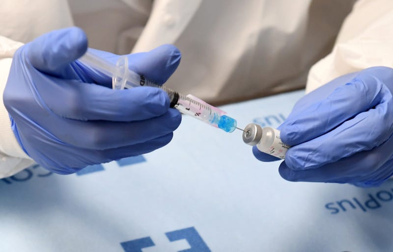 Student pharmacist Wilbur Quimba dilutes vials of the Pfizer-BioNTech COVID-19 vaccine at University Medical Center of Southern Nevada on December 16, 2020, in Las Vegas, Nevada.