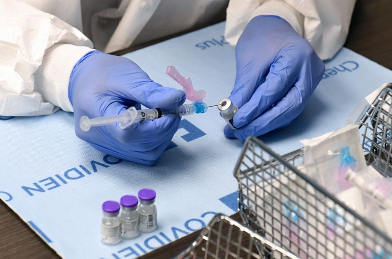 Student pharmacist Wilbur Quimba dilutes vials of the Pfizer-BioNTech COVID-19 vaccine at University Medical Center of Southern Nevada on December 16, 2020, in Las Vegas, Nevada