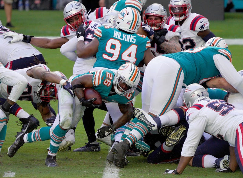 Salvon Ahmed stumbles for the score against the Patriots.