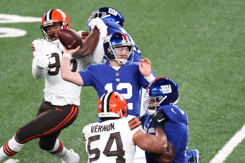 Colt McCoy fires a pass against his former team, the Cleveland Browns.