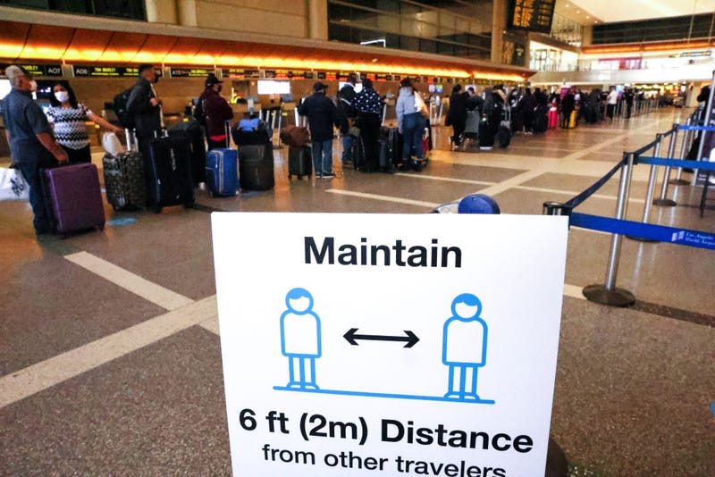 Travelers wait in line to check in for a flight at the Tom Bradley International Terminal at Los Angeles International Airport (LAX) amid a COVID-19 surge in Southern California on December 22, 2020 in Los Angeles, California. TSA agents screened over 1 million people for three consecutive days last Friday, Saturday and Sunday, the beginning of the traditional holiday travel season, for the first time since the start of the coronavirus pandemic.