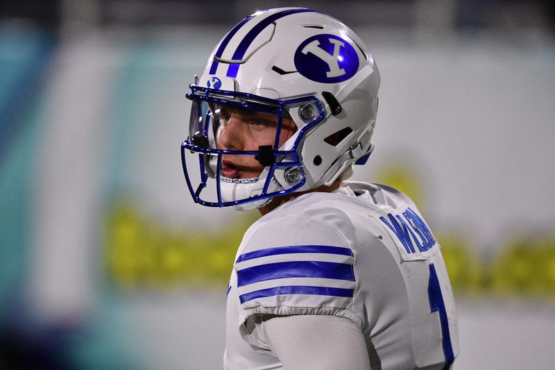 BYU quarterback Zach Wilson looks on.