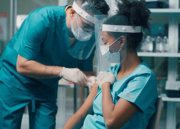 Hospital worker getting vaccinated stock photo. 