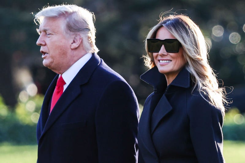 Former President Donald Trump and first lady Melania Trump walk on the south lawn of the White House on December 23, 2020 in Washington, DC.