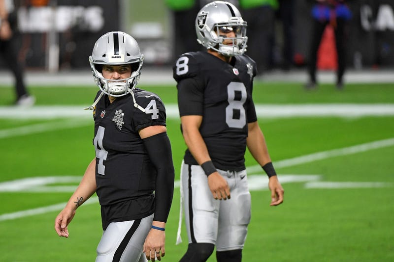Derek Carr and Marcus Mariota warm up prior to a game.