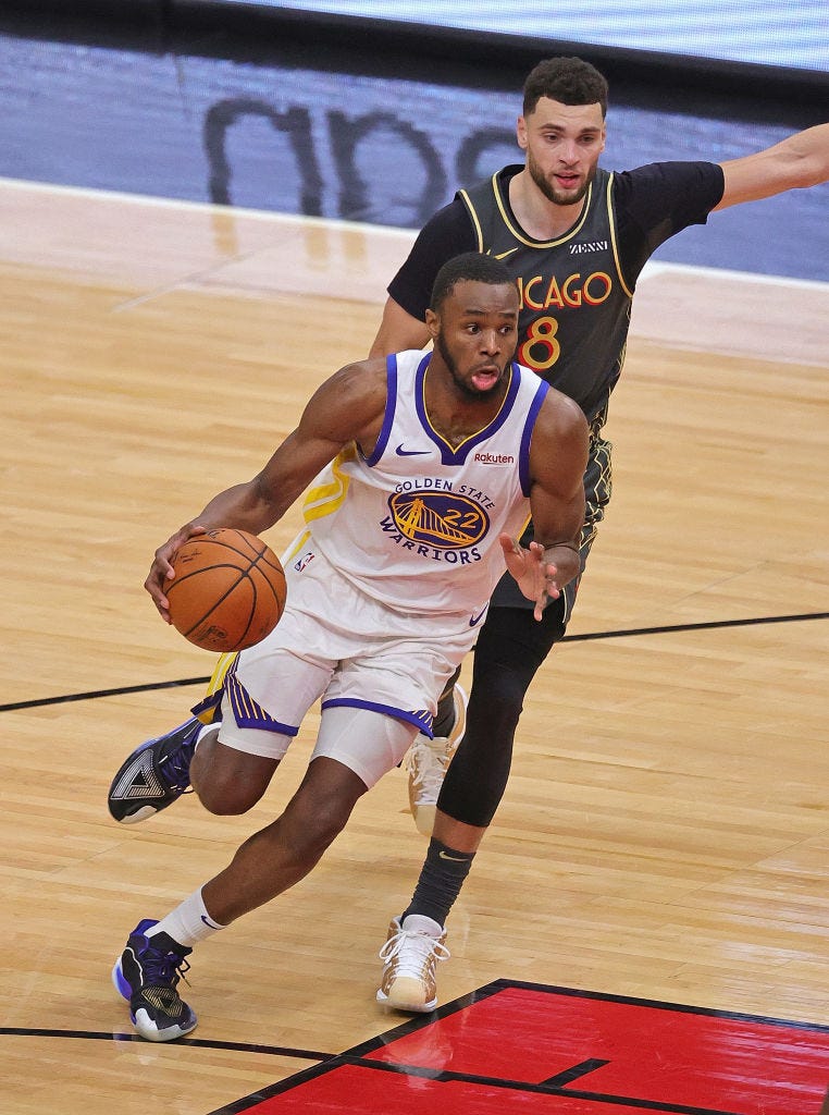 Andrew Wiggins #22 of the Golden State Warriors drives past Zach LaVine #8 of the Chicago Bulls at the United Center on December 27, 2020 in Chicago, Illinois.