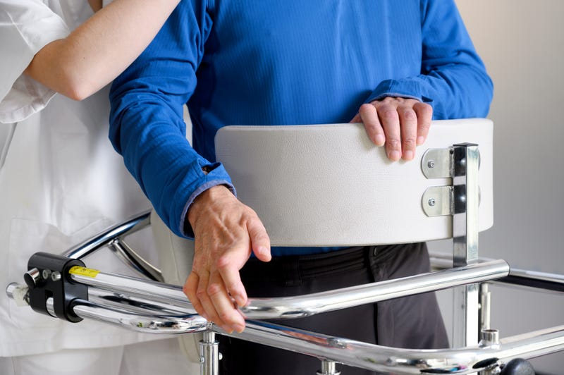 Physiotherapist assisting a patient with Amyotrophic Lateral Sclerosis.