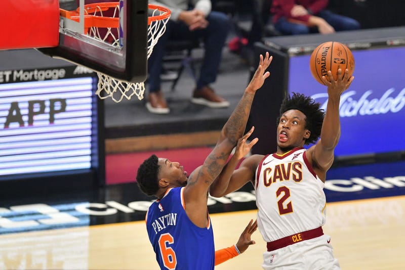 Collin Sexton lays the ball up over Elfrid Payton.