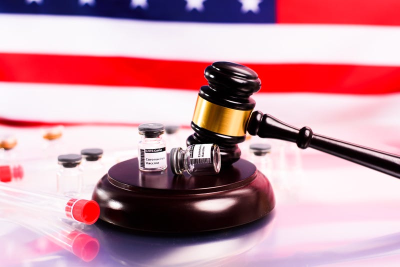 Gavel and COVID vaccine bottles