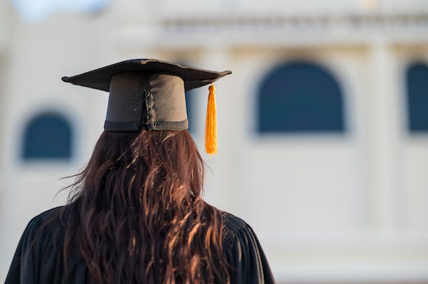Woman wearing a cap and gown during Graduation
