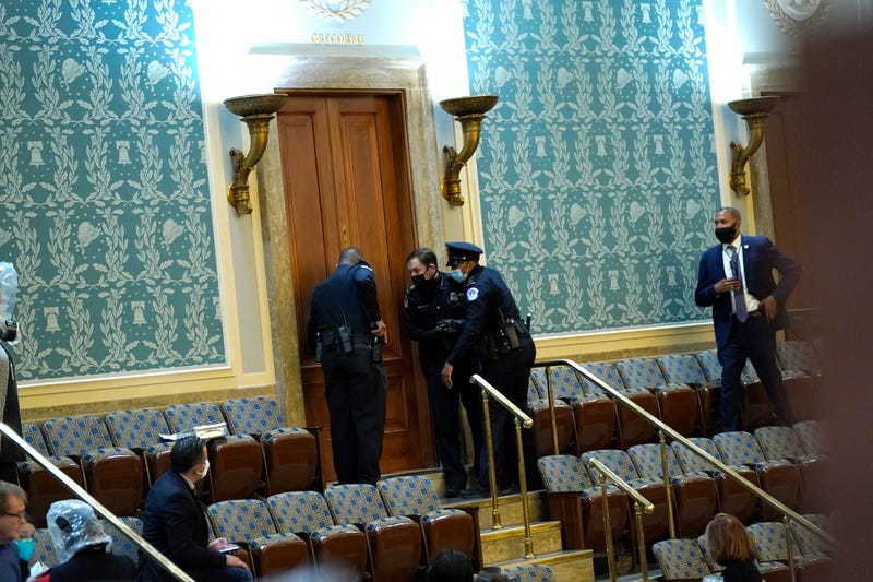 U.S. Capitol Police draw their guns as protesters attempt to enter the House Chamber during a joint session of Congress on January 06, 2021 in Washington, DC. Congress held a joint session today to ratify President-elect Joe Biden's 306-232 Electoral College win over President Donald Trump. A group of Republican senators said they would reject the Electoral College votes of several states unless Congress appointed a commission to audit the election results. 
