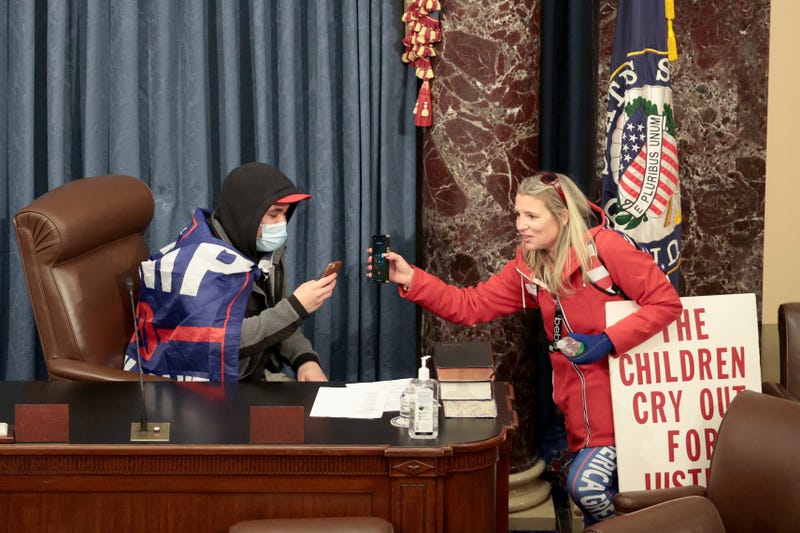 A protester sits in the Senate Chamber on January 06, 2021 in Washington, DC. Congress held a joint session today to ratify President-elect Joe Biden's 306-232 Electoral College win over President Donald Trump. Pro-Trump protesters have entered the U.S. Capitol building after mass demonstrations in the nation's capital. 