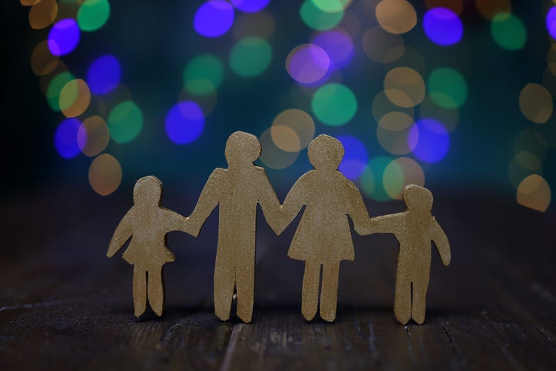 Family wood cutout in front of light stock photo. 
