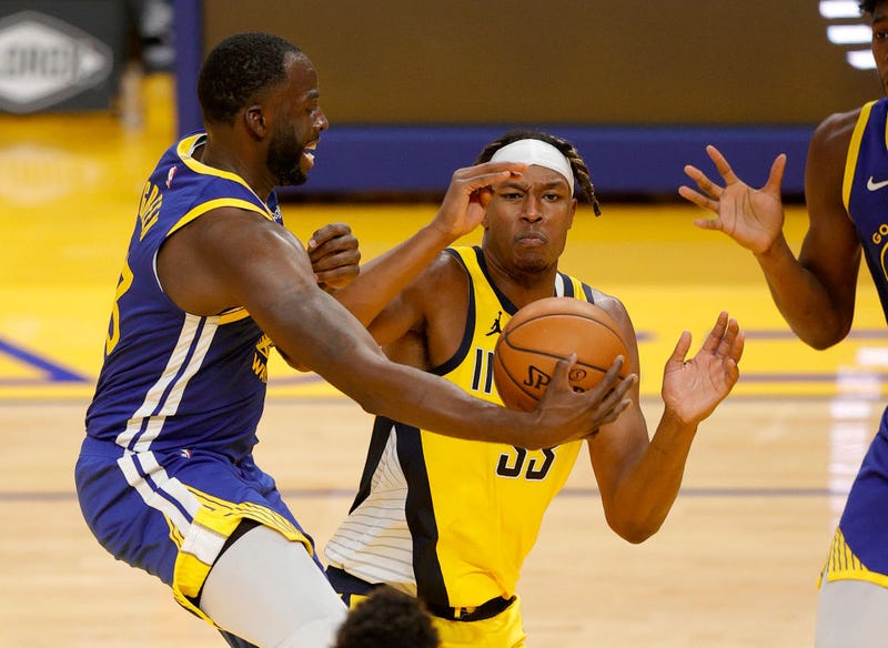 Miles Turner disrupts a play from Draymond Green