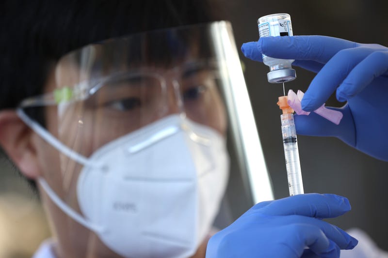 Safeway pharmacist Preston Young fills a syringe with Moderna COVID-19 vaccination during a drive-thru COVID-19 vaccination clinic at the Sonoma County Fairgrounds on January 13, 2021 in Santa Rosa, California.