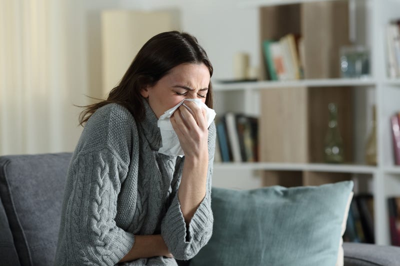 woman blowing nose stock photo. 