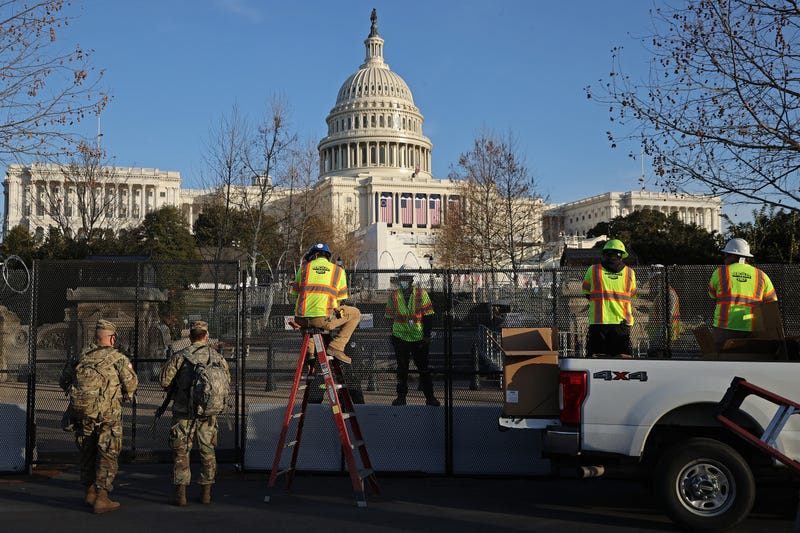 Workers put concertina razor wire along the top of the 8-foot 'non-scalable' fence that surrounds the U.S. Capitol the day after the House of Representatives voted to impeach President Donald Trump for the second time January 14, 2021 in Washington, DC. Thousands of National Guard troops have been activated to protect the nation's capital against threats surrounding President-elect Joe Biden’s inauguration and to prevent a repeat of last week’s deadly insurrection at the U.S. Capitol. 