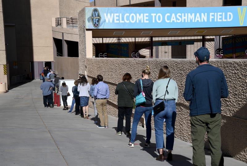 People wait in line to receive a coronavirus vaccination at the Cashman Center in downtown Las Vegas