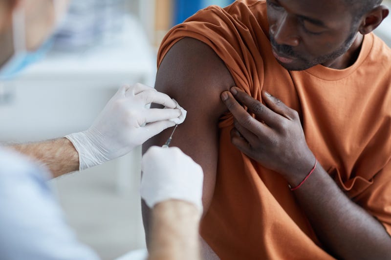Black man gets COVID-19 vaccine