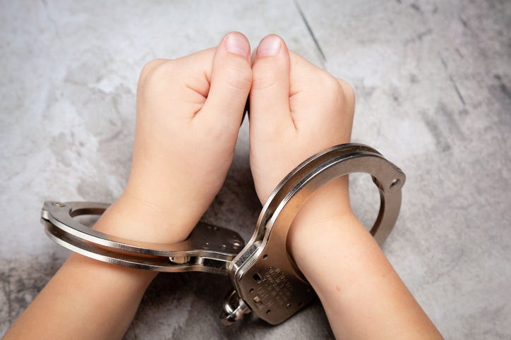 File image of a teen in handcuffs