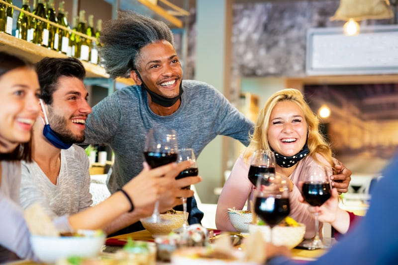 People dining while wearing masks.
