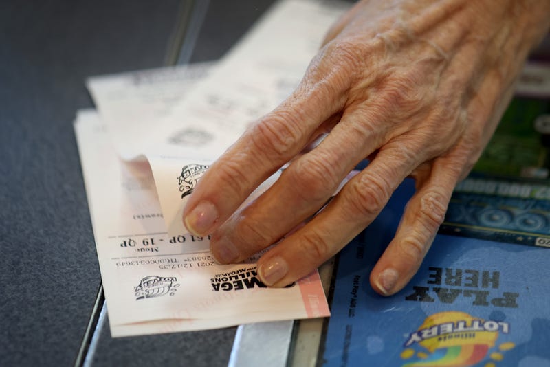 CHICAGO, ILLINOIS - JANUARY 22: A customer purchases a Mega Millions lottery ticket at a 7-Eleven store in the Loop on January 22, 2021 in Chicago, Illinois. The jackpot in the drawing has climbed to $970 million, the third highest in the game's history.