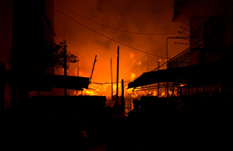 Houses, apartment, flat on fire and burning down at night in the market, slum, local center community, downtown in the big city. Asian cityscape location. - stock photo