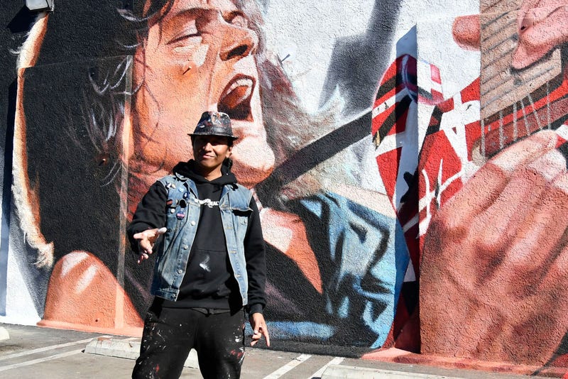 Artist Robert Vargas in front of his mural.