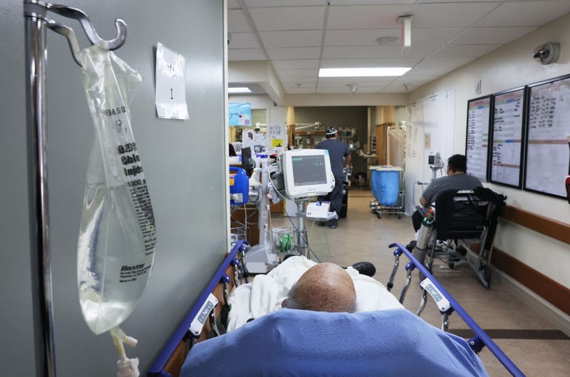 Patients rest in a hallway in the overloaded Emergency Room area at Providence St. Mary Medical Center.