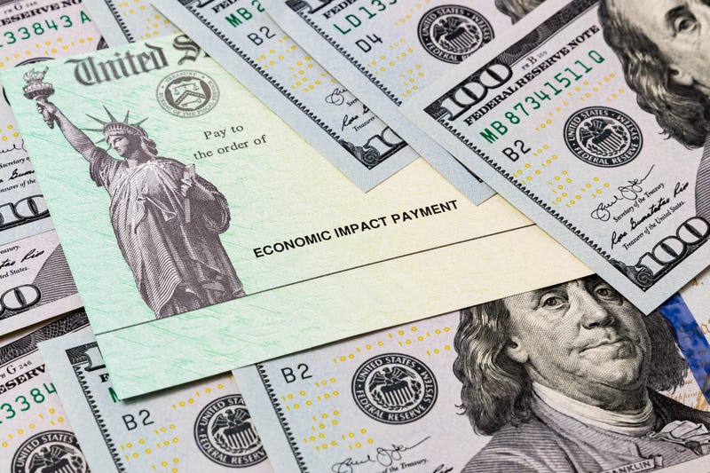 Coronavirus economic impact check surrounded by money.