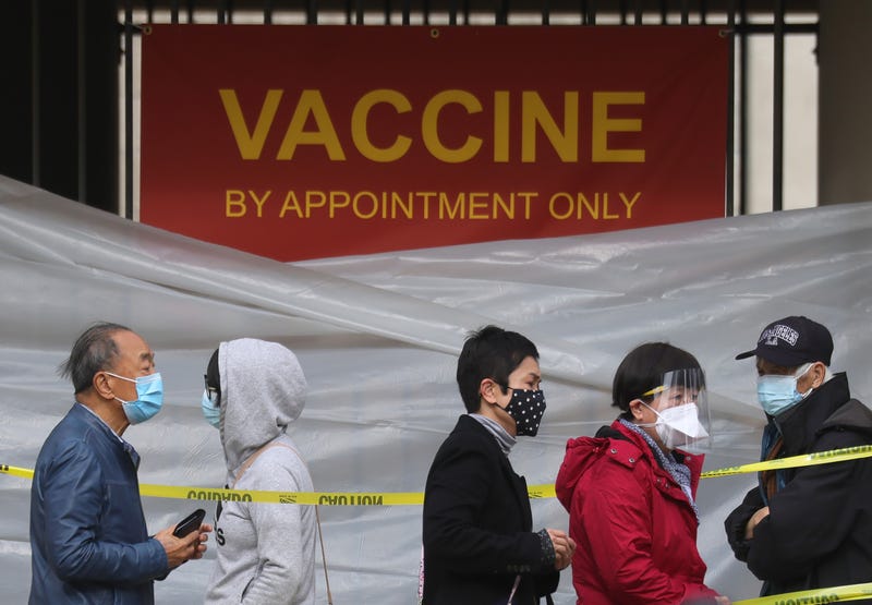 People with appointments stand in line to receive the COVID-19 vaccine at a vaccination site at Lincoln Park in East Los Angeles amid eased lockdown restrictions on January 28, 2021 in Los Angeles, California.