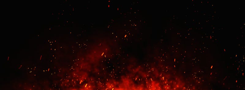 Fire sparks background. Abstract dark glitter fire particles lights. bonfire in motion blur.