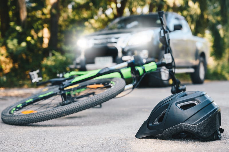 bicycle and helmet fallen on the road after a car accident
