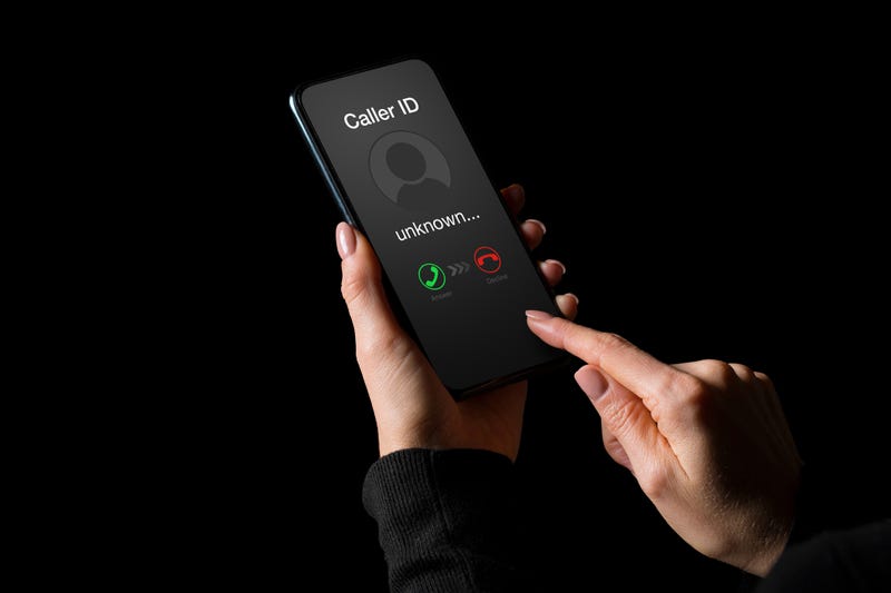 FILE - Person receiving a call on phone from an unknown number