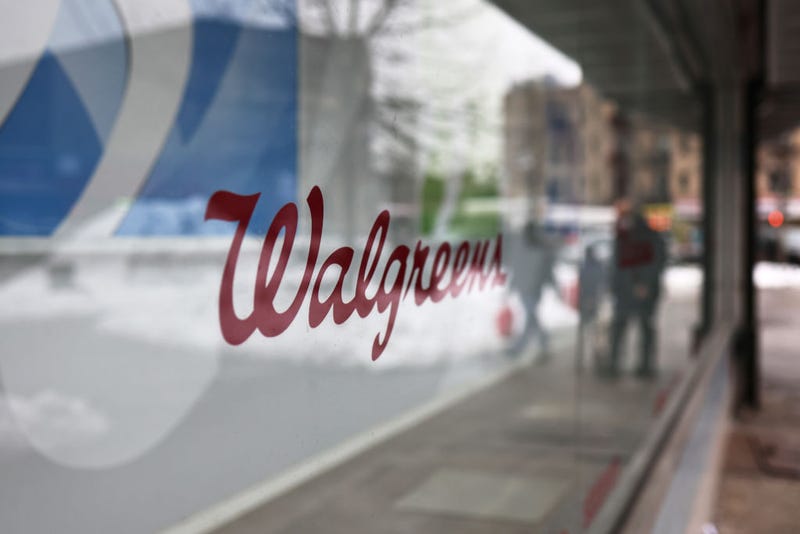 A Walgreens signage is seen on a storefront window 