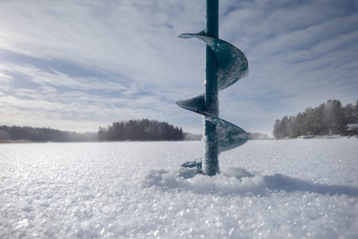 An ice fishing hole being drilled. 