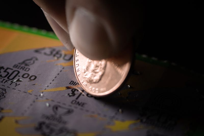 Person playing a scratch of lottery ticket. 