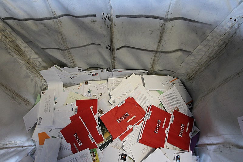 Netflix envelopes sit in a bin with other mail at the San Francisco Post Office sort facility on October 24, 2011 in San Francisco, California.
