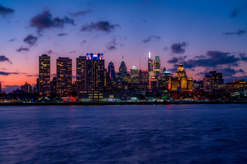 The Philadelphia Skyline from the Delaware River after sunset with illuminated skyscrapers