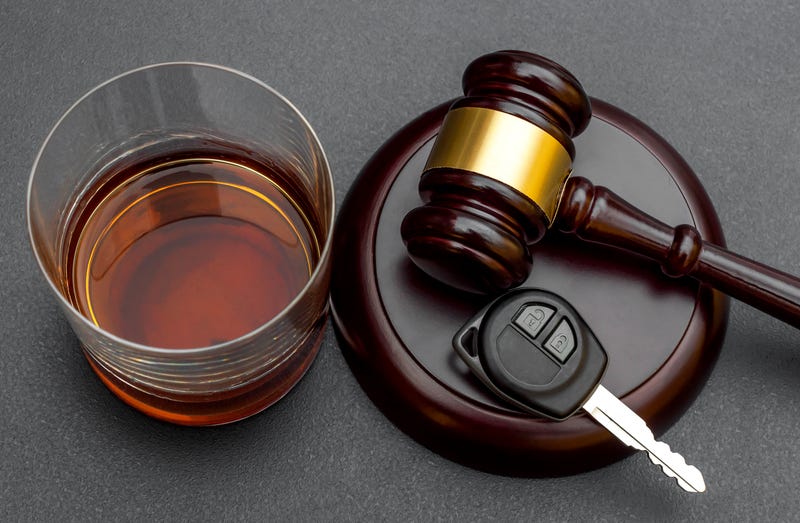 Alcohol, car key and gavel