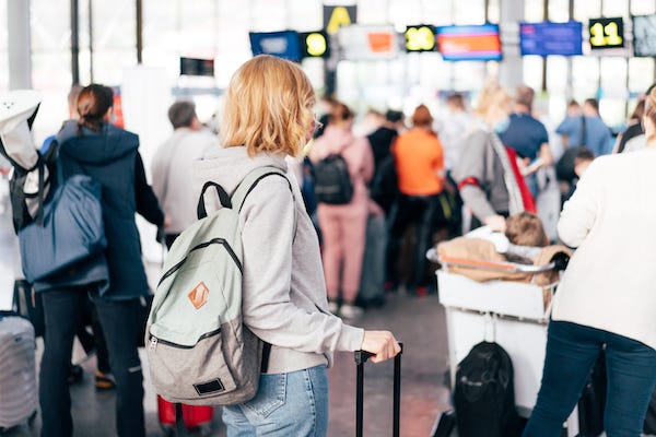 People waiting to board at a gate in an airport