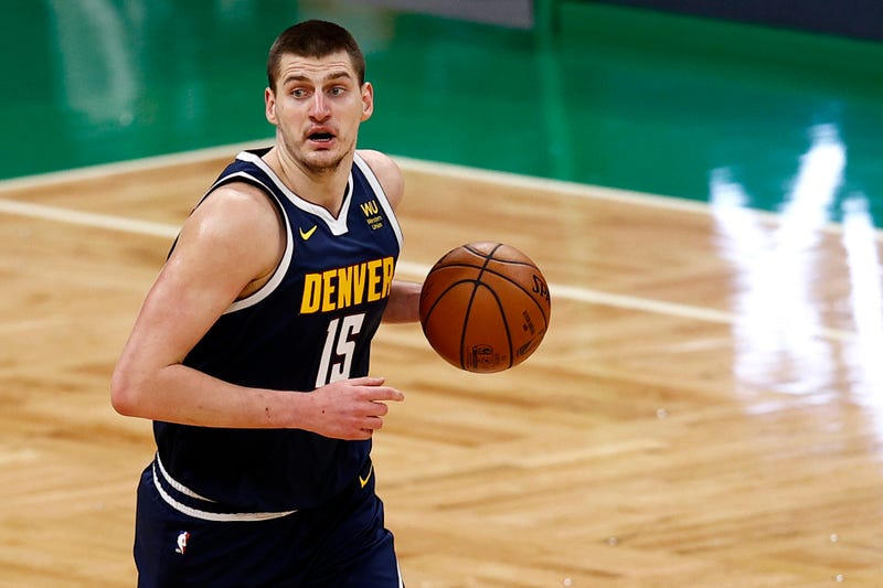 Denver Nuggets center Nikola Jokic dribbles up the court.
