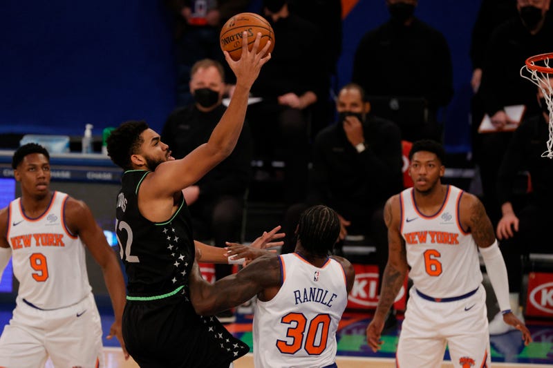 Karl-Anthony Towns #32 of the Minnesota Timberwolves shoots Julius Randle #30 of the New York Knicks defends during the first half at Madison Square Garden on February 21, 2021 in New York City.