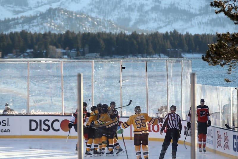The Bruins celebrate a first-period goal with Lake Tahoe in the background