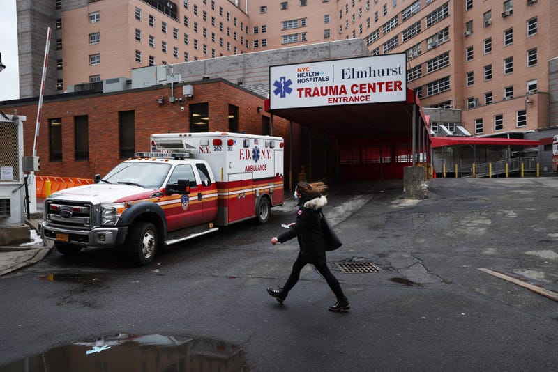 File photo: A person walks by a hospital in a neighborhood among those that have seen some of the highest number of city Covid-19 deaths on February 23, 2021 in the Queens borough of New York City