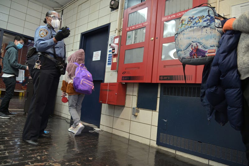 An NYPD School Safety Agent ushers students into school on Feb. 25, 2021.