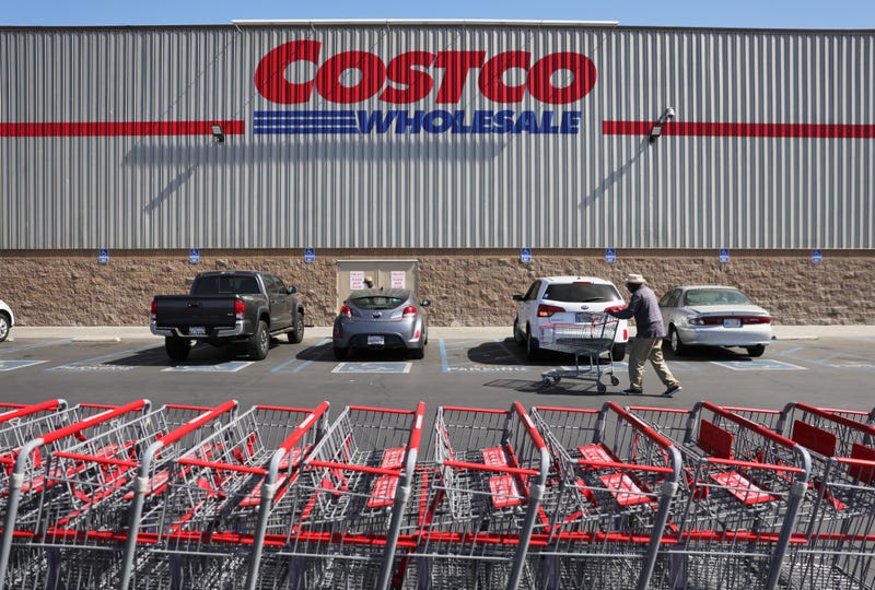 A shopper walks in front of a Costco store.