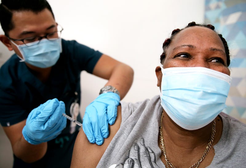Lorraine Harvey, an in-home care worker, receives her first dose of the COVID-19 vaccine from registered nurse Rudolfo Garcia at a clinic at Martin Luther King Jr. Community Hospital in South Los Angeles on February 25, 2021 in Los Angeles, California.