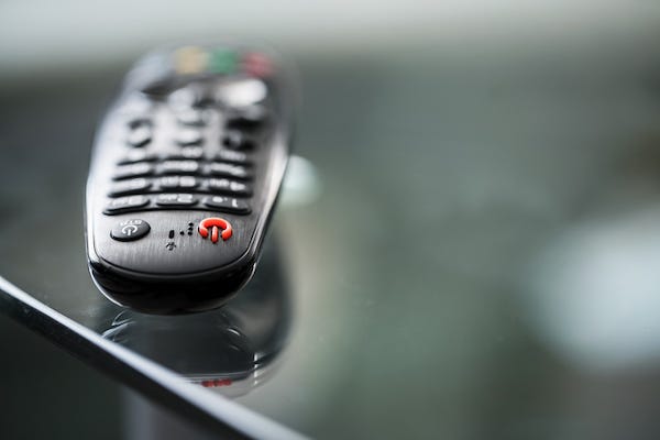 Remote control laying on glass table