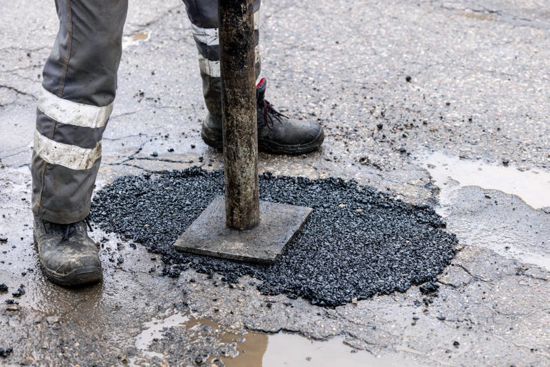 worker repairing a pothole
